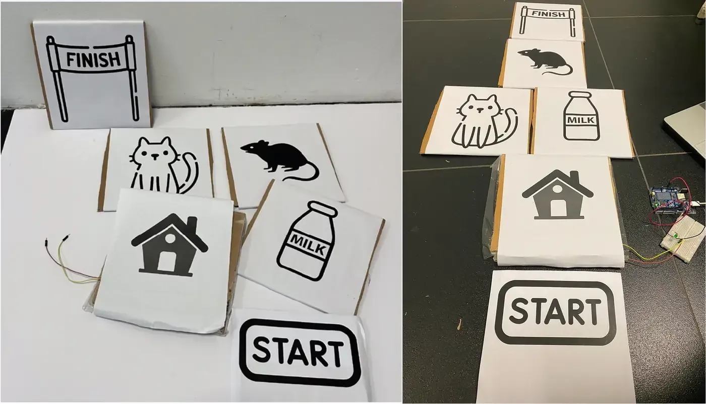 Two photographs of the paper prototype, cardboard tiles wrapped in white paper and printed with black icons for start, a house, a cat, a mouse, a milk bottle and finish, laid out as a hopscotch path on the floor and wired to an Arduino board and breadboard with an LED
